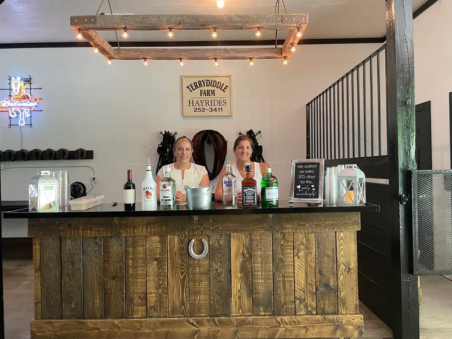 The rustic horseshoe bar in the barn