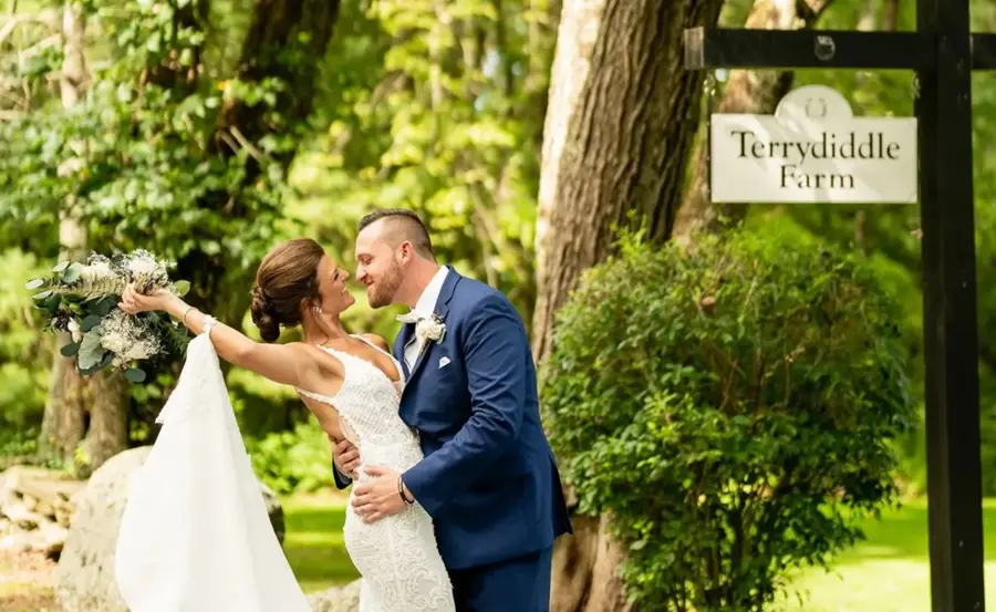 Couple embracing by the Terrydiddle Farm sign
