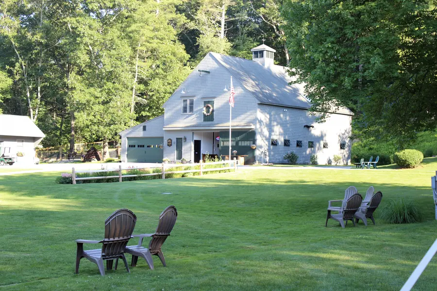 The barn across the lawn with Adirondack chairs