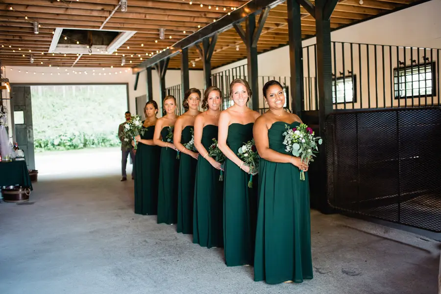 Bridesmaids lined up in the barn
