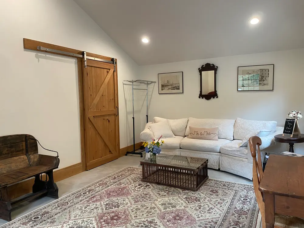 The bridal suite sitting room with a sofa and barn door